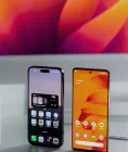An iPhone and an Android phone standing side by side on a desk