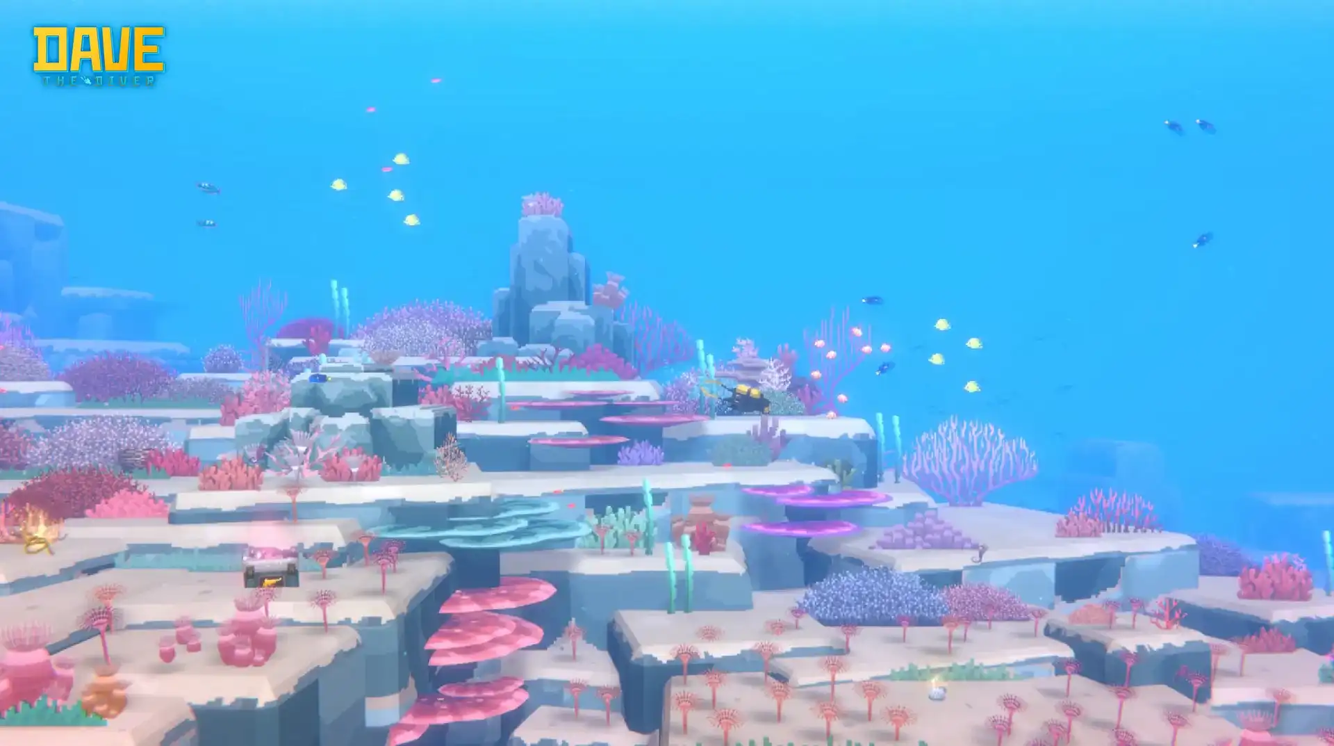 DAVE THE DIVER bright coral reef with pink and purple growth, small fish shoals and a tiny diver near the centre