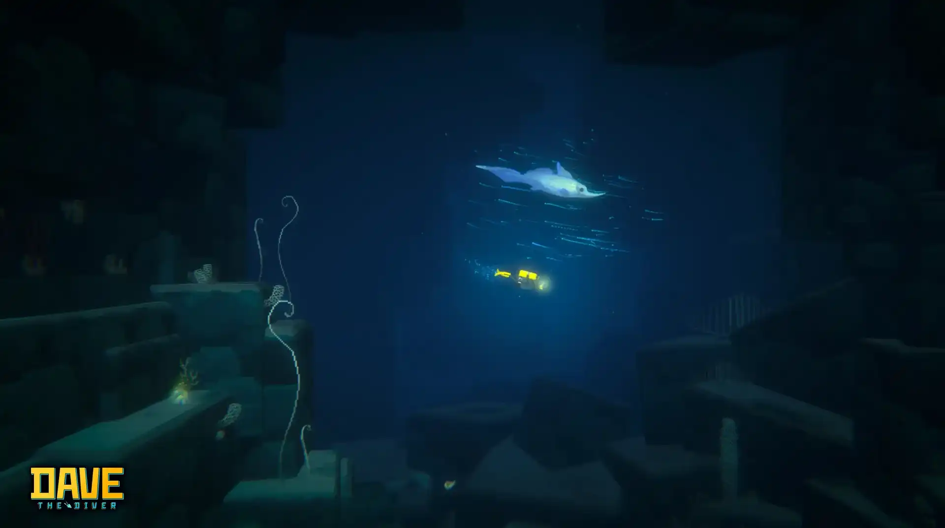 DAVE THE DIVER dark deep-water scene with a pale ray swimming above a very small yellow diver between rock walls