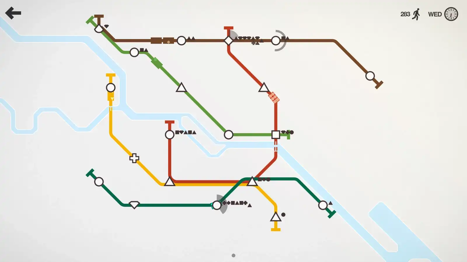 Mini Metro network with several colored routes and passenger queues around crowded stations
