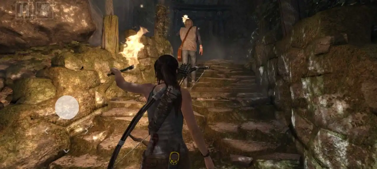 Lara Croft follows another survivor through torch-lit ruins using mobile touch controls